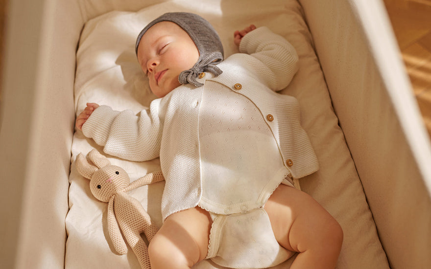 Why do babies sleep with their arms up?